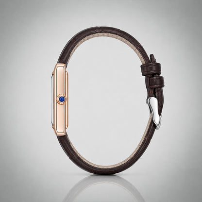 Side profile of the 1927 gold tank case with blue cabochon crown and brown leather strap